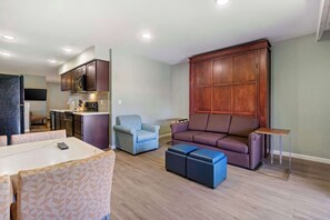 Desk, laptop workspace, iron/ironing board, travel cot