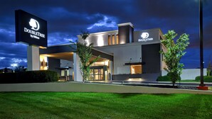 A modern hotel with a prominent DoubleTree by Hilton sign, a well-lit entrance, and a landscaped front yard. - DoubleTree by Hilton St. Louis Airport (St. Louis)