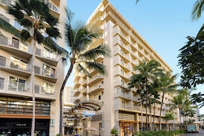 A multi-story hotel with balconies, palm trees, and a sign for Wyndham Vacation Ownership. - Club Wyndham at Waikiki Beach Walk (Honolulu)