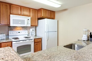 Fridge, microwave, coffee/tea maker, cookware/dishes/utensils