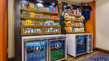A vending area with snacks, drinks, and a T-shirt rack.