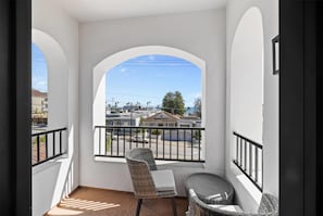 Suite, 1 King Bed, Non Smoking, Partial Ocean View (Hearing Impaired) | Desk, laptop workspace, blackout drapes, iron/ironing board