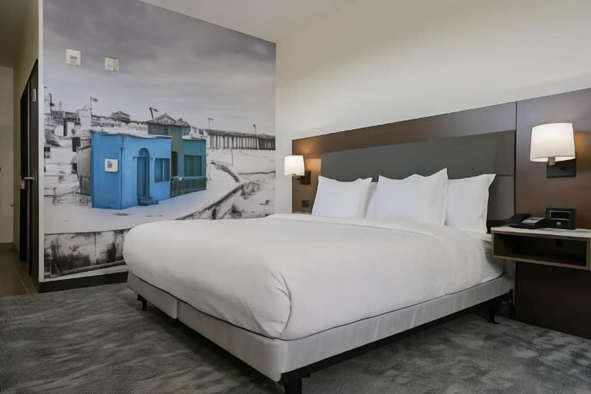 Desk, laptop workspace, blackout drapes, iron/ironing board