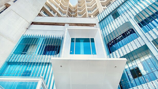A modern building with a glass facade, a central atrium, and a symmetrical design. - Romance Alexandria Hotel (Alexandria)