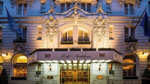 The exterior of Hotel Monteleone with ornate architectural details, a grand entrance, and a flag. - Hotel Monteleone, New Orleans (New Orleans)