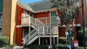 A multi-story building with a staircase leading to a balcony. - Extended Stay of Charleston (North Charleston)