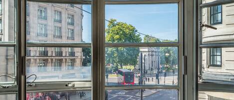 A corner window with a view of a street and buildings.