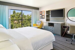 Relax in this serene retreat with a large bed, flat-screen TV, and balcony overlooking the surrounding trees and mountains.