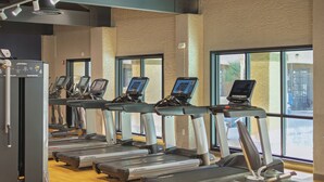A gym with treadmills, a stationary bike, and a rowing machine. - Sheraton Tucson Hotel and Suites (Tucson)