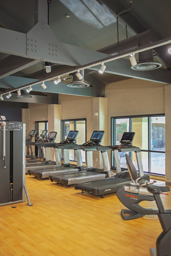A gym with treadmills, a stationary bike, and a rowing machine. - Sheraton Tucson Hotel and Suites (Tucson)