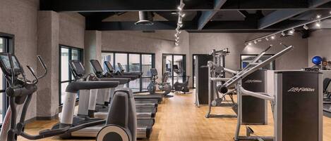 A gym with treadmills, ellipticals, and weight machines.