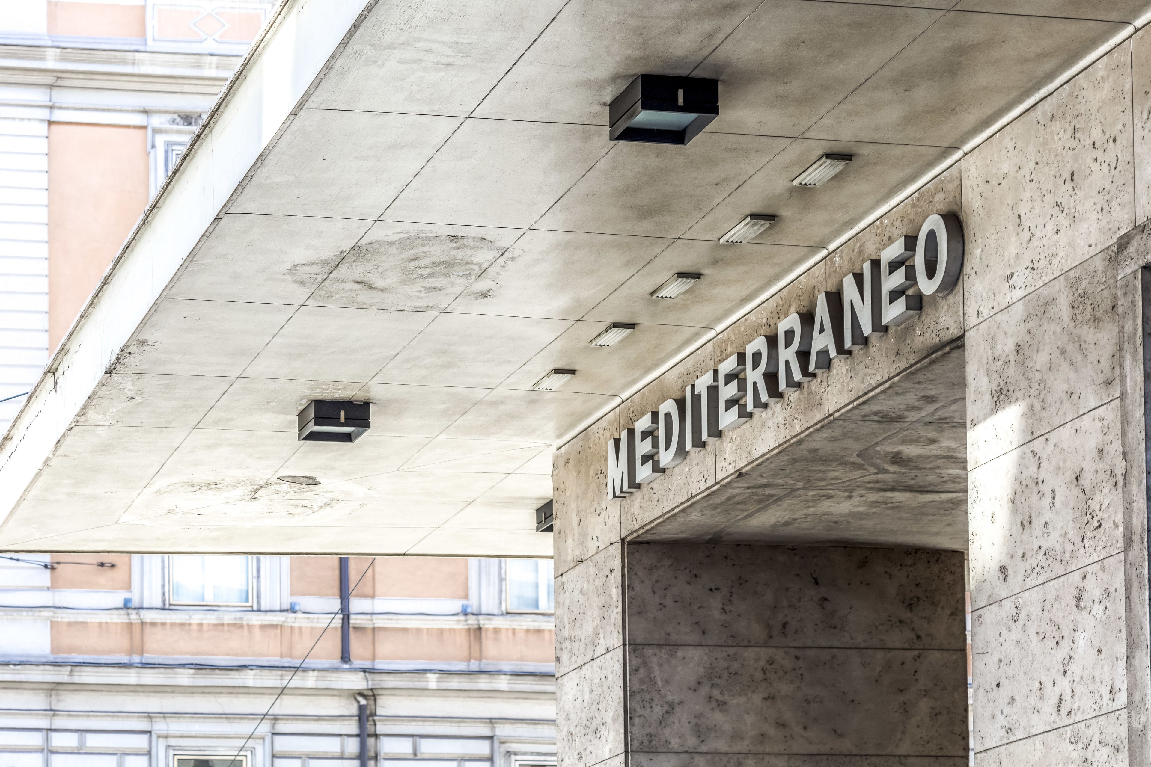 A building facade with the name "MEDITERRANEO" prominently displayed.