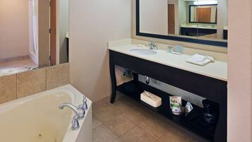 A bathroom with a bathtub, a sink, a mirror, and a shelf with toiletries.