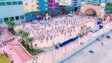 A large outdoor plaza with numerous seating areas and a stage for performances.