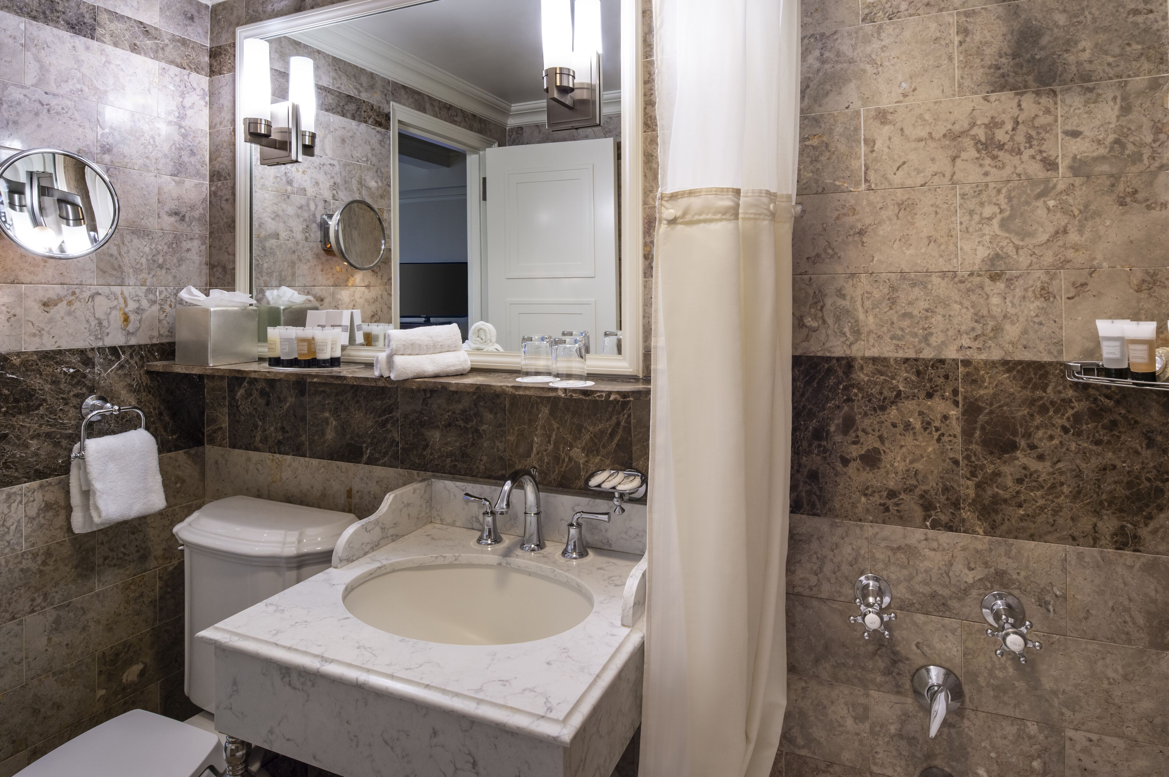 combined shower/bathtub, designer toiletries, hair dryer, towels