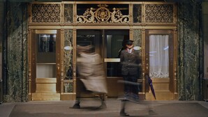 A hotel entrance with ornate gold detailing and a sign reading "THE WARWICK". - Warwick New York (New York)