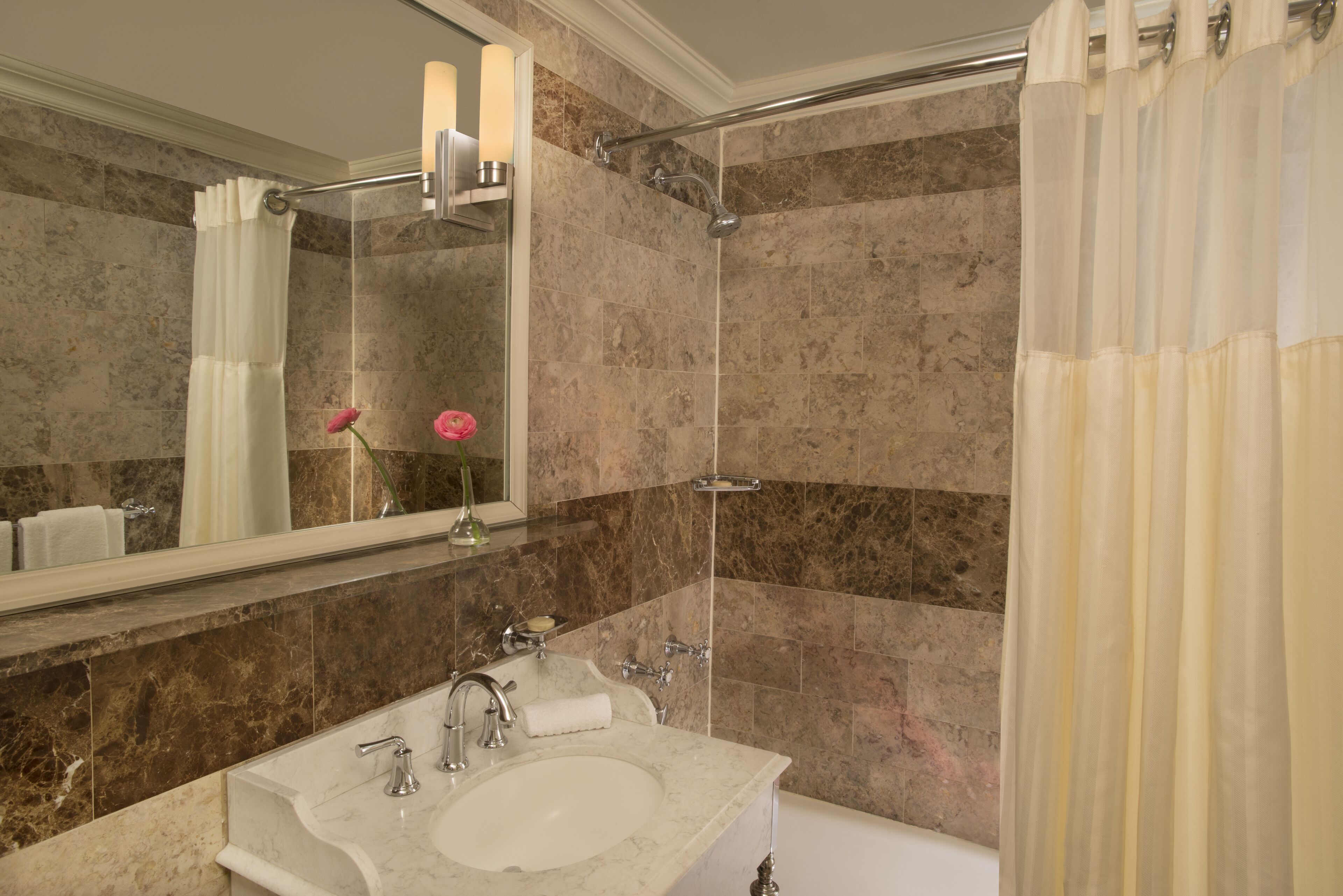 combined shower/bathtub, designer toiletries, hair dryer, towels
