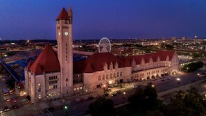 A large historic building with a prominent tower and a large dome, surrounded by a well-lit urban area. - St. Louis Union Station Hotel, Curio Collection by Hilton (St. Louis)