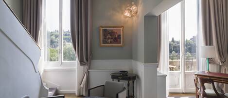 Una habitación con escalera, comedor y vistas a la ciudad.
