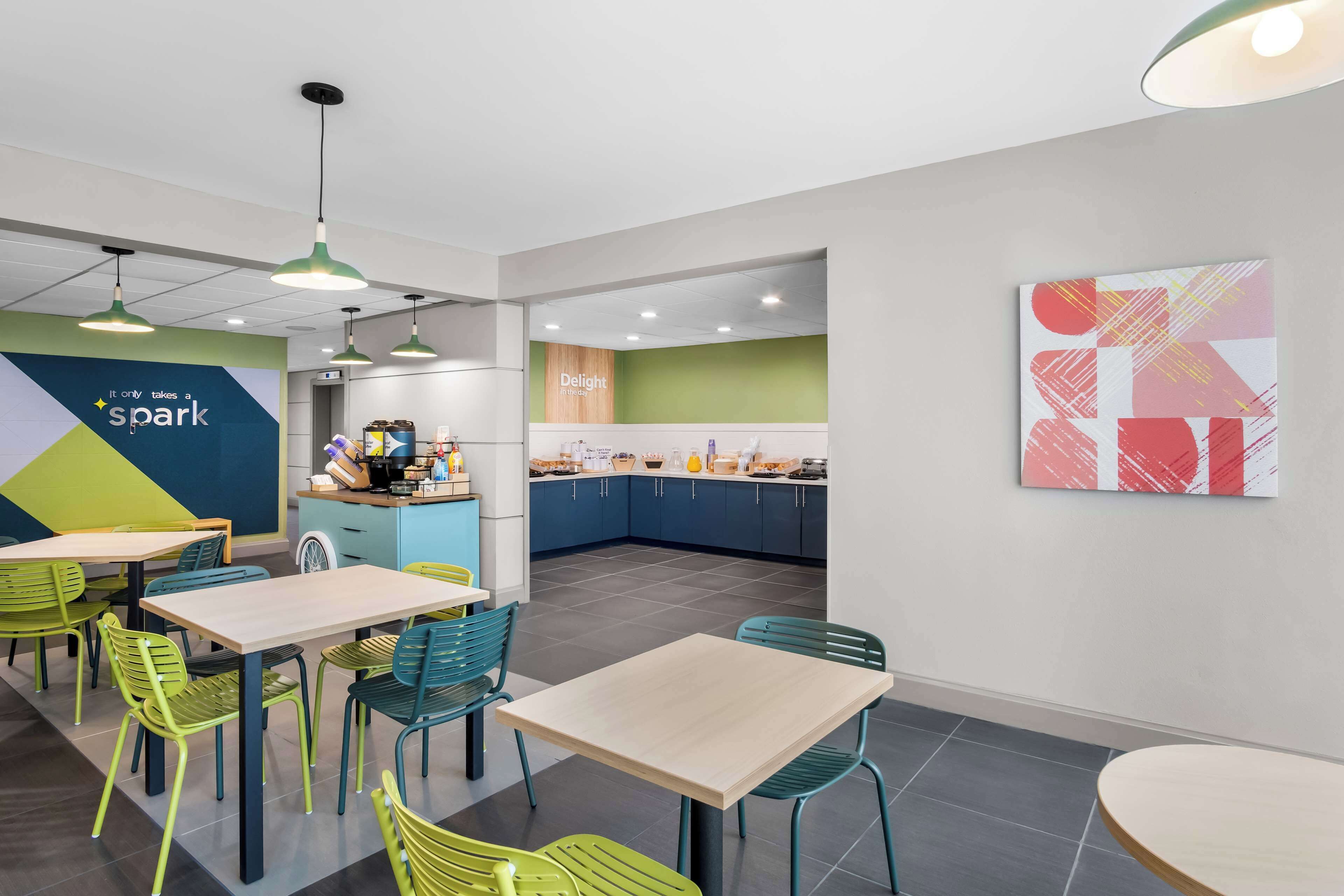 A modern cafe with a counter, tables, and chairs.