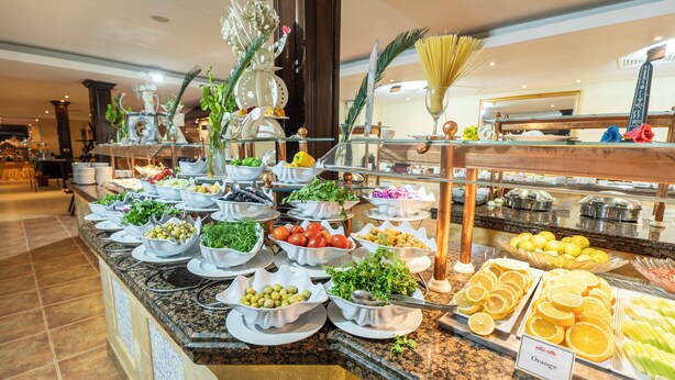 A buffet with various food items and a sign indicating 'Orange' section. - Jolie Ville Hotel & Spa Kings Island Luxor (Luxor)
