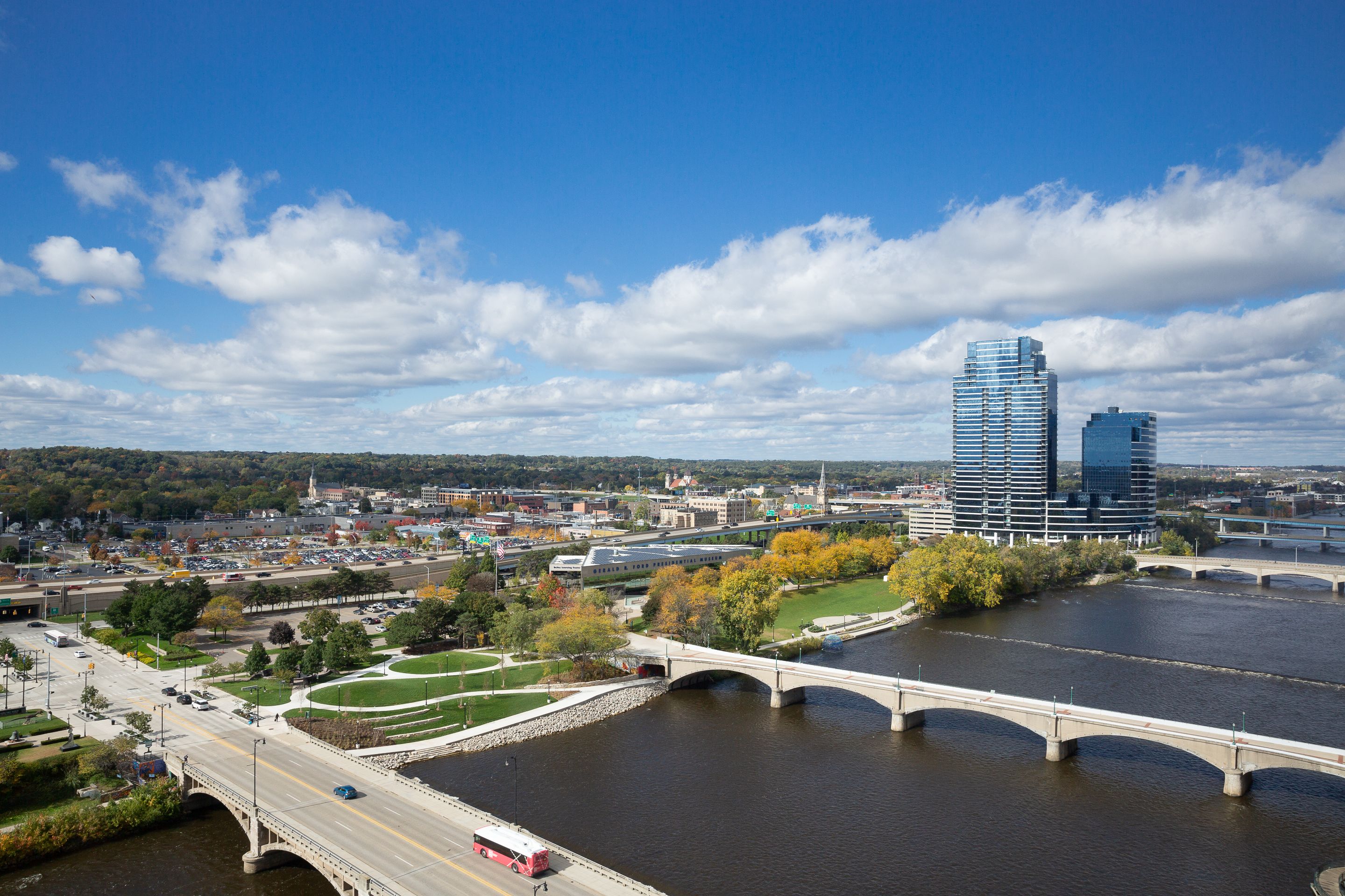 A cityscape with a river, bridges, and modern buildings.