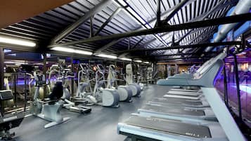 A gym with treadmills, elliptical machines, and weight equipment.