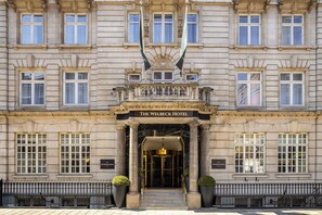 The exterior of The Welbeck Hotel with a grand entrance, large windows, and a symmetrical facade. - The Welbeck Hotel, by IHG (London)