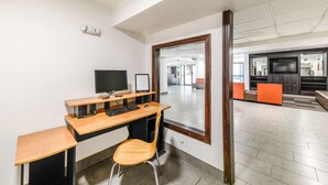 A modern office space with a wooden desk, a computer, and a chair. - Motel 6 Lewisville, TX - Medical City (Lewisville)