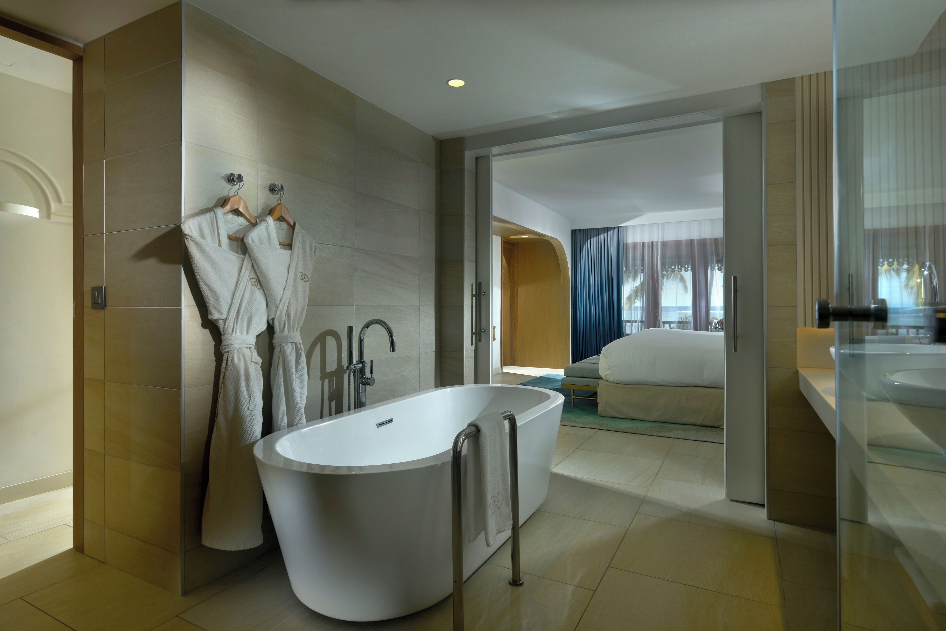 A modern bathroom with a freestanding bathtub, a glass shower enclosure, and a large mirror.