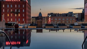 Relax by the rooftop pool surrounded by city views and lush greenery.