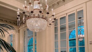 A luxurious lobby with a grand chandelier, large windows, and a patterned floor. - The St. Anthony, A Luxury Collection Hotel, San Antonio (San Antonio)