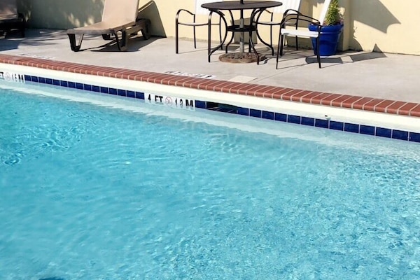 Seasonal outdoor pool, open 9:00 AM to 9:00 PM, pool umbrellas