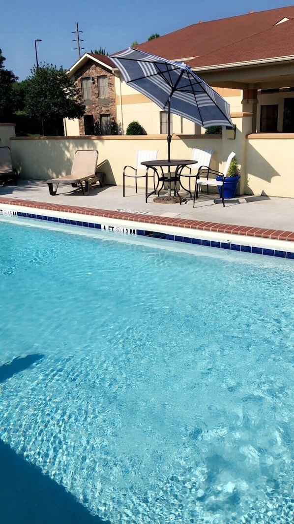 Seasonal outdoor pool, open 9:00 AM to 9:00 PM, pool umbrellas