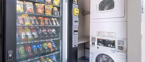 A vending machine with snacks and drinks, and a washing machine.