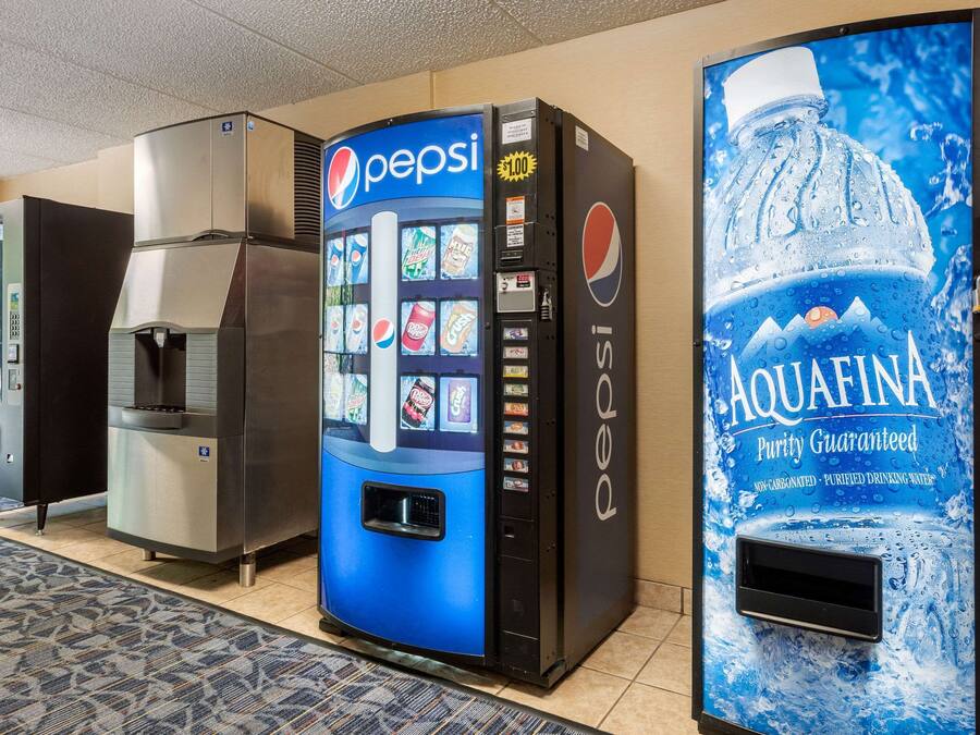 A vending machine area with a Pepsi machine, a water dispenser, and an Aquafina water vending machine.