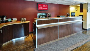 A reception desk with a sign indicating free Wi-Fi availability. - Red Roof Inn Louisville East - Hurstbourne (Louisville)
