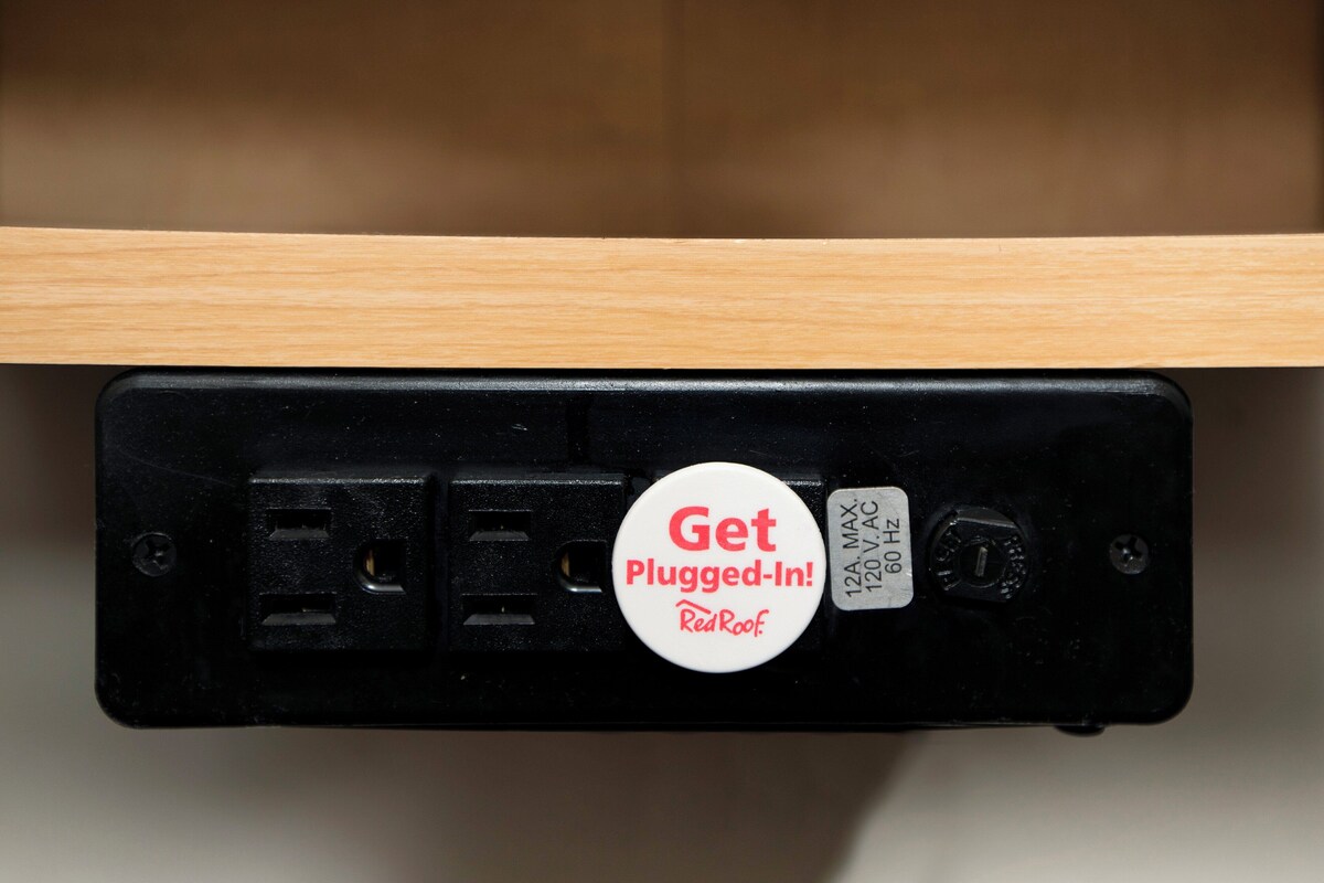 A power strip with a "Get Plugged-In!" badge and a label indicating "120V AC 60 Hz".