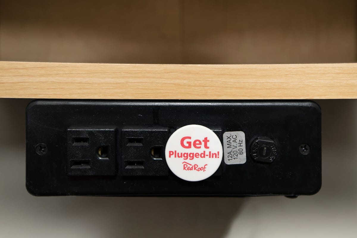 A power strip with a "Get Plugged-In!" badge and a label indicating "120V AC 60 Hz".