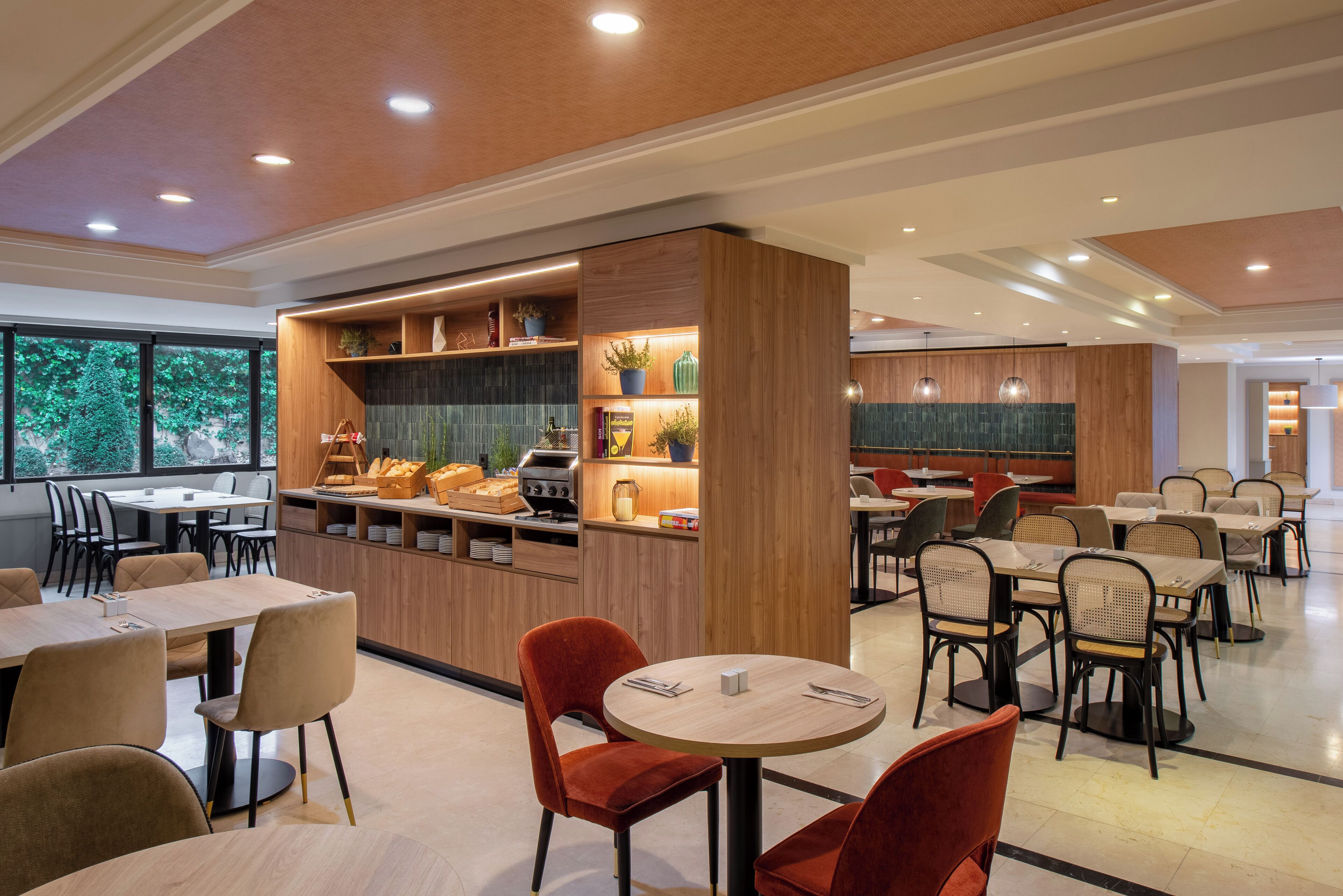 A modern dining area with wooden furniture, round tables, and a central kitchen island.