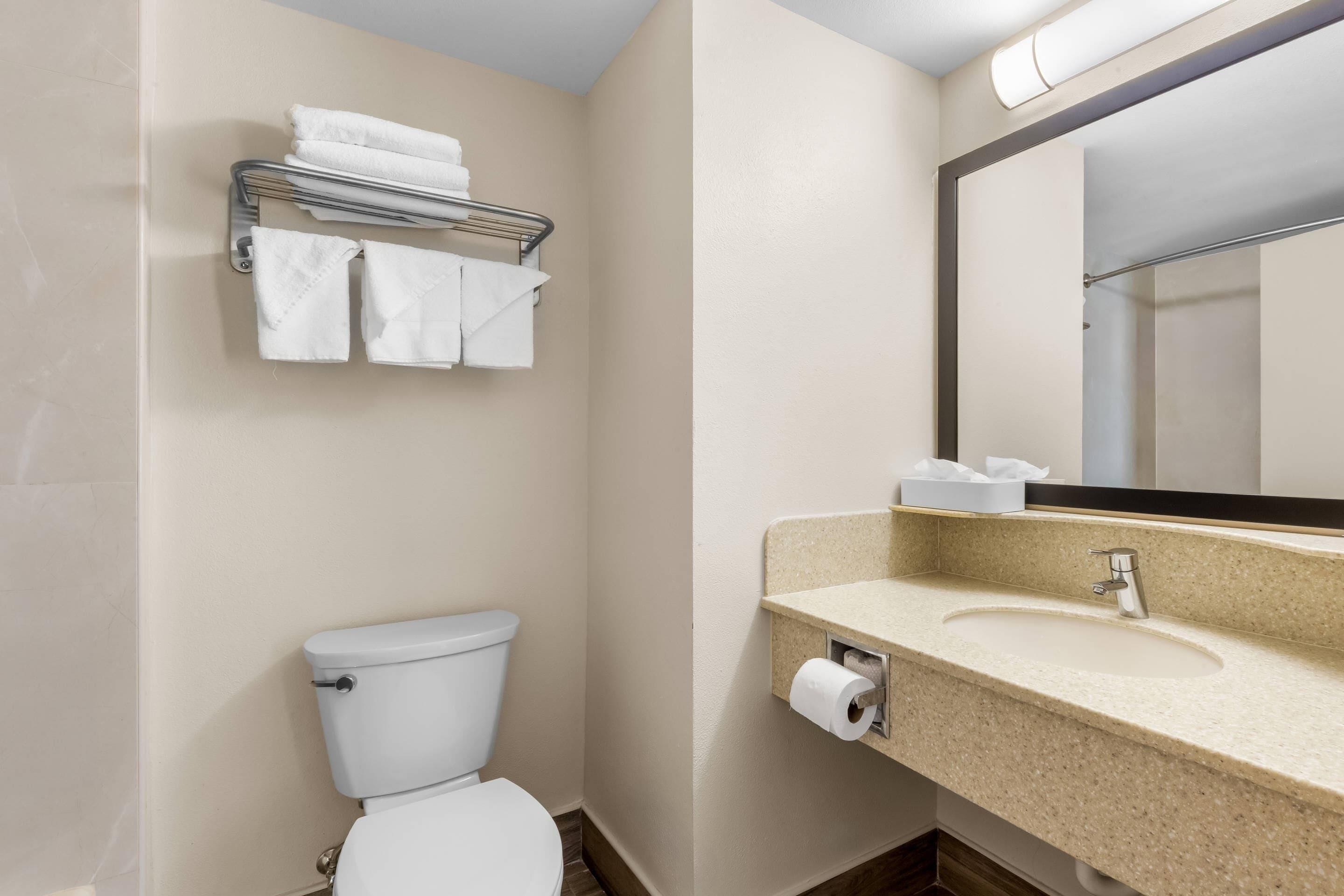 A small bathroom with a toilet, a sink, and a towel rack.