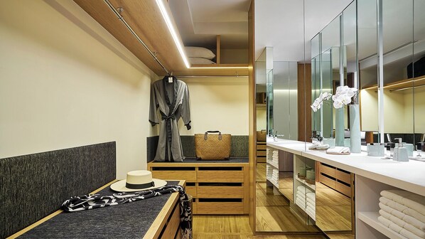 A modern bathroom with a vanity, mirror, and storage cabinets. - Chiva-Som Hua Hin (Hua Hin)