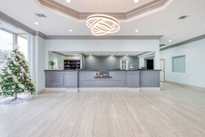 A spacious kitchen with a central island, grey cabinetry, and a modern pendant light. - Hotel elev8 (Conroe)