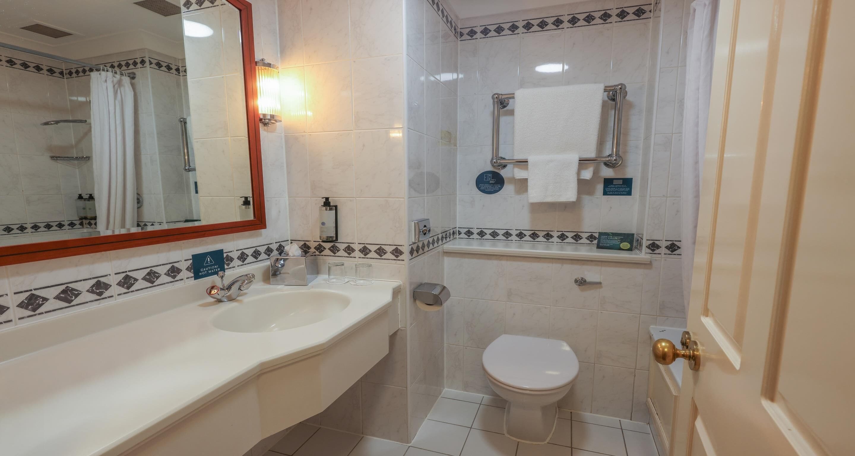 A bathroom with a sink, toilet, and shower.