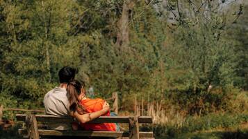 Sit comfortably on this sturdy bench amidst lush foliage.