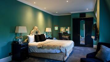 A bedroom with a bed, nightstands, a chair, and a dresser.