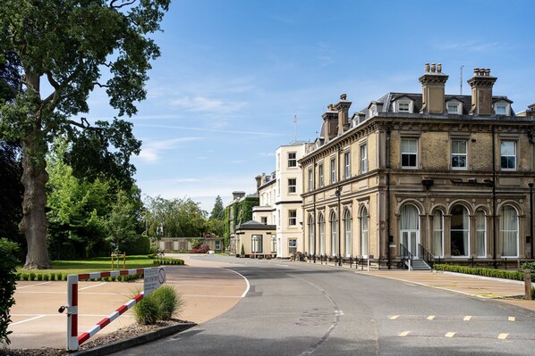 A historic building with classical architecture, a gated entrance, and a well-maintained lawn. - The Spa Hotel (Royal Tunbridge Wells)