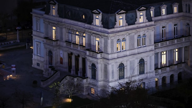 A multi-story building with classical architecture, featuring a central courtyard and a symmetrical facade with evenly spaced windows.