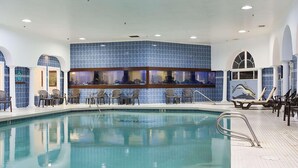 An indoor swimming pool with a tiled wall and multiple viewing windows. - Shilo Inn Suites Ocean Shores (Ocean Shores)