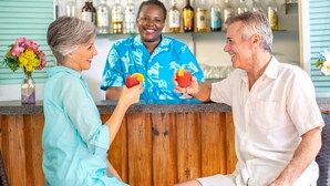 A bar area with a wooden counter and a variety of liquor bottles in the background. - Bay View Suites Paradise Island (Paradise Island)